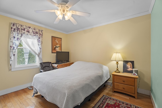 bedroom featuring crown molding, wood-type flooring, and ceiling fan