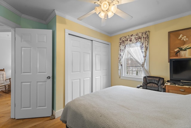 bedroom featuring crown molding, a closet, and hardwood / wood-style flooring