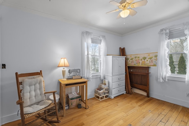 sitting room with crown molding, ceiling fan, and light wood-type flooring