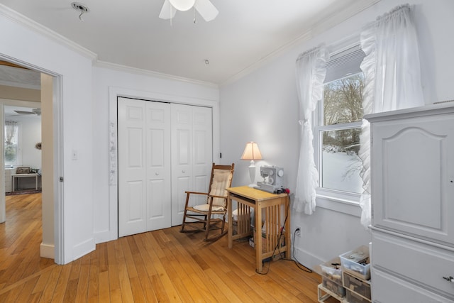 living area featuring crown molding, ceiling fan, and light hardwood / wood-style floors