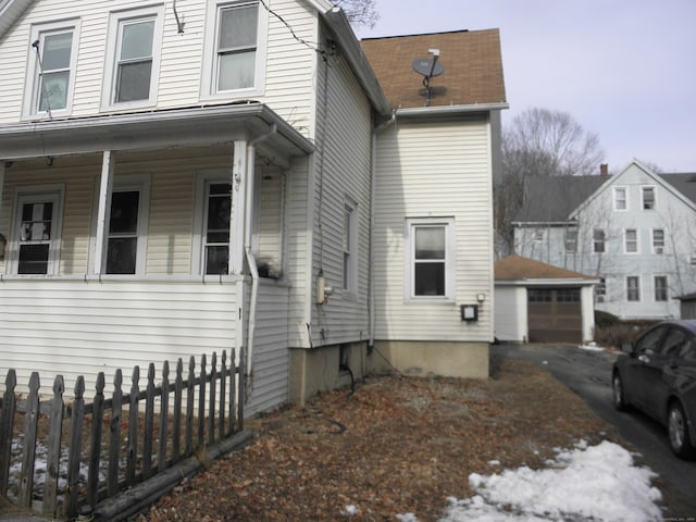 exterior space with an outbuilding, a garage, and covered porch