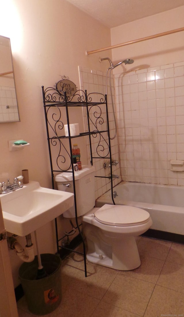 bathroom with toilet, tile patterned flooring, and shower / bathing tub combination