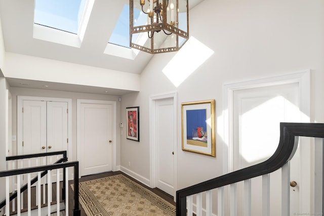 1060 Harbor Rd, Fairfield, CT 06890 - entryway featuring a skylight, high vaulted ceiling, wood finished floors, and baseboards