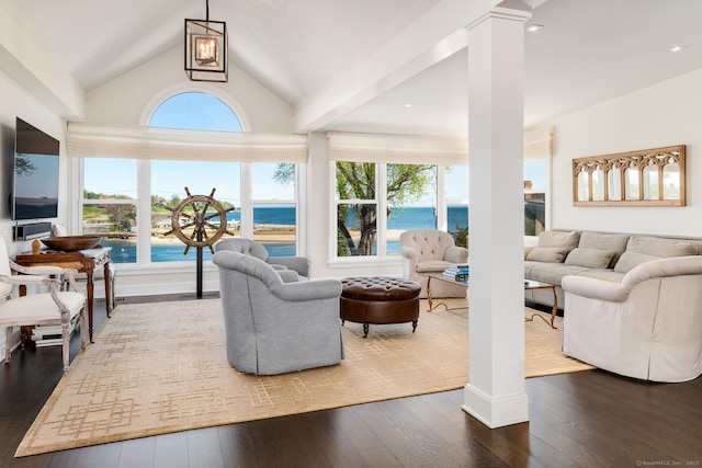 1060 Harbor Rd, Fairfield, CT 06890 - living room with healthy amount of natural light, dark wood-type flooring, decorative columns, and lofted ceiling