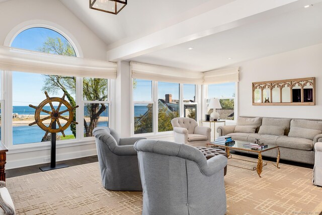1060 Harbor Rd, Fairfield, CT 06890 - living area featuring vaulted ceiling, a water view, wood finished floors, and recessed lighting