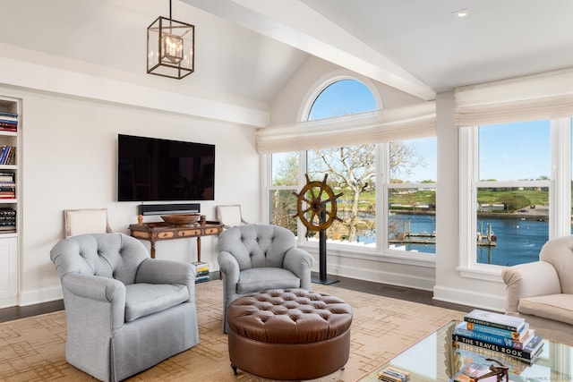 1060 Harbor Rd, Fairfield, CT 06890 - living area with lofted ceiling, wood finished floors, a chandelier, and baseboards
