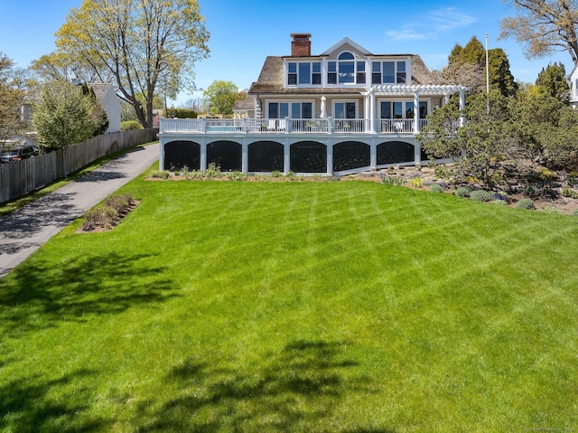 1060 Harbor Rd, Fairfield, CT 06890 - back of house with a chimney