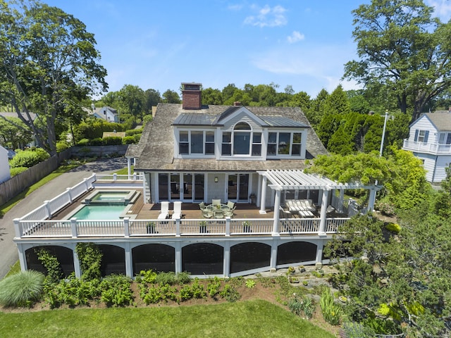 1060 Harbor Rd, Fairfield, CT 06890 - rear view of house featuring an in-ground hot tub, a chimney, and a pergola