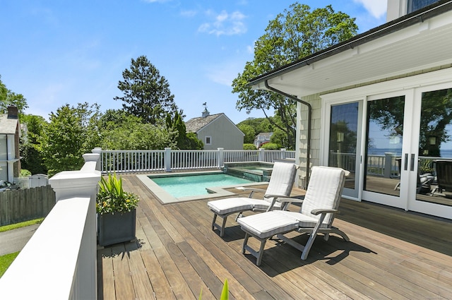 1060 Harbor Rd, Fairfield, CT 06890 - view of swimming pool with a wooden deck, a pool with connected hot tub, and french doors
