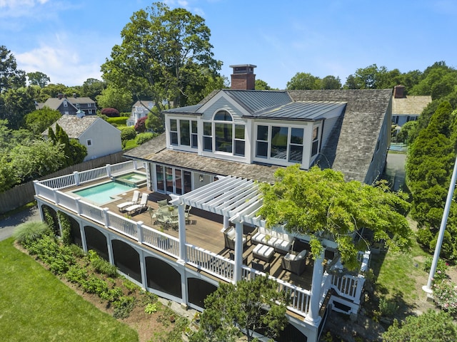 1060 Harbor Rd, Fairfield, CT 06890 - rear view of house with a pergola, a chimney, a standing seam roof, a fenced backyard, and metal roof