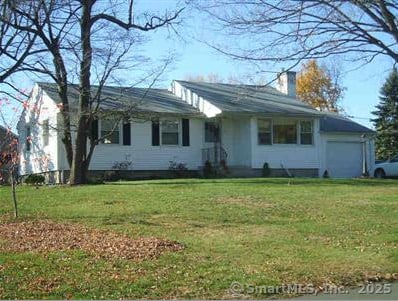 ranch-style home featuring a garage and a front yard