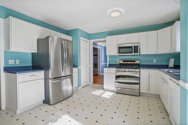 kitchen featuring white cabinetry, stainless steel appliances, and sink