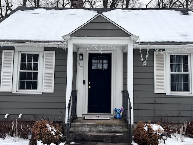 view of snow covered property entrance