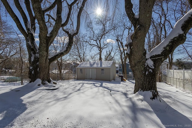 yard covered in snow with an outdoor structure