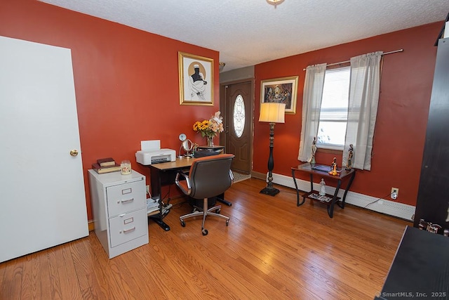 office with a textured ceiling and light wood-type flooring