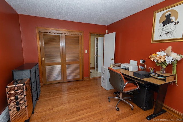 office space featuring light hardwood / wood-style floors and a textured ceiling