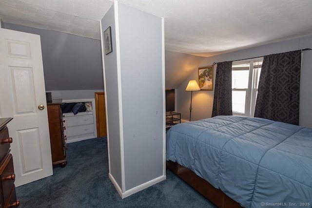 carpeted bedroom with vaulted ceiling