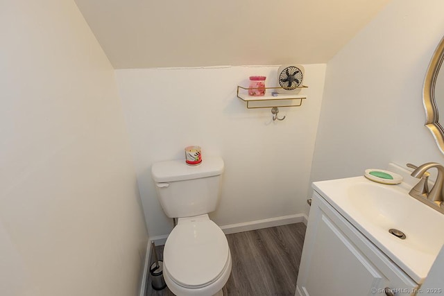 bathroom with vanity, hardwood / wood-style floors, and toilet