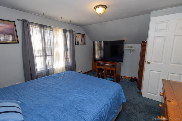 carpeted bedroom with vaulted ceiling