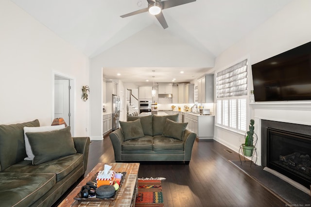 living room with high vaulted ceiling, dark wood-type flooring, sink, and ceiling fan