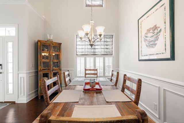 dining space featuring a chandelier, dark hardwood / wood-style floors, and a healthy amount of sunlight