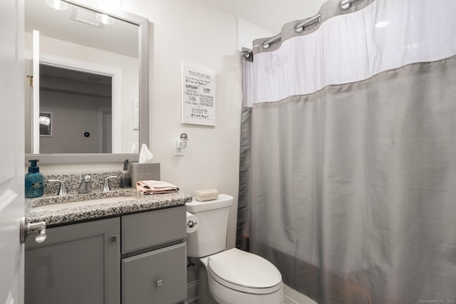 full bathroom with vanity, toilet, and shower / tub combo with curtain