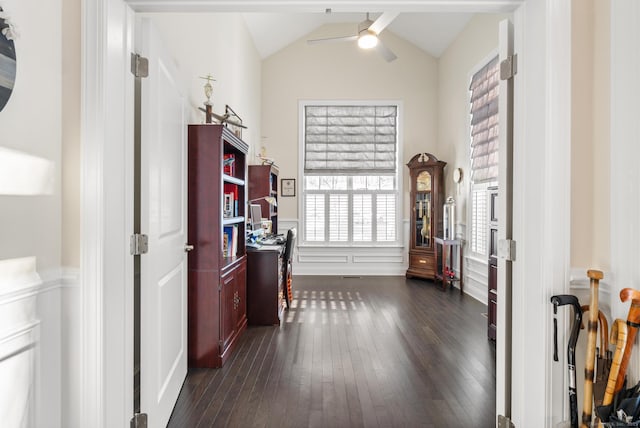 interior space featuring ceiling fan, lofted ceiling, and dark hardwood / wood-style flooring