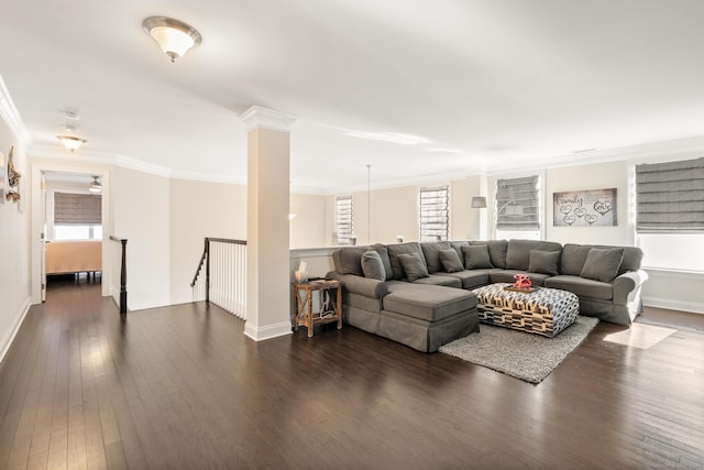 living room featuring ornate columns, ornamental molding, a healthy amount of sunlight, and dark hardwood / wood-style flooring