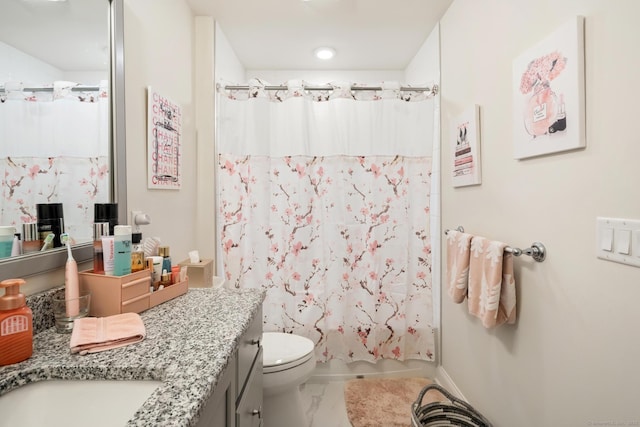 full bathroom featuring vanity, shower / tub combo, and toilet