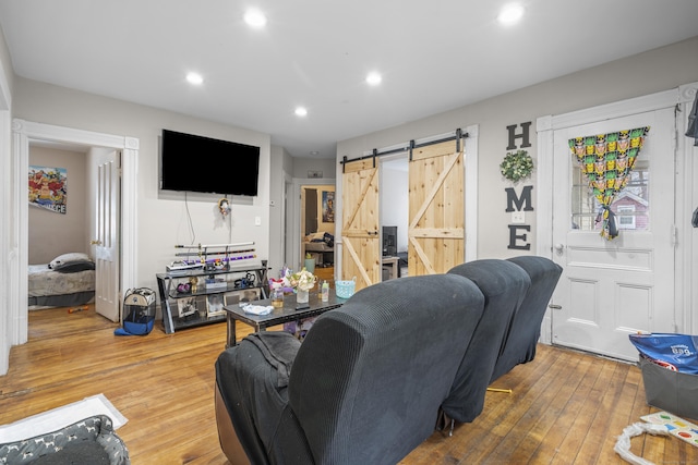 living room featuring hardwood / wood-style flooring and a barn door