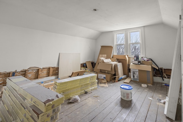 additional living space with vaulted ceiling and light hardwood / wood-style floors