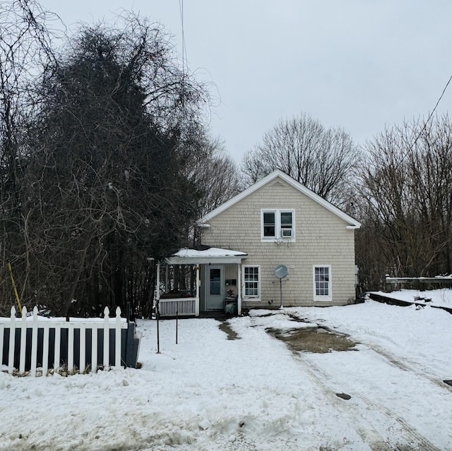 view of front of home with a deck and fence