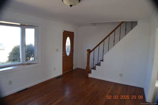 entryway with stairway, wood finished floors, visible vents, and baseboards