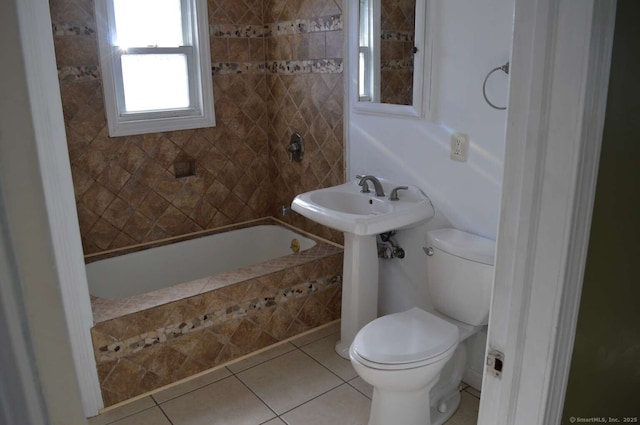 full bath featuring tile patterned flooring, tiled shower / bath, and toilet