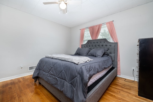 bedroom with hardwood / wood-style flooring and ceiling fan