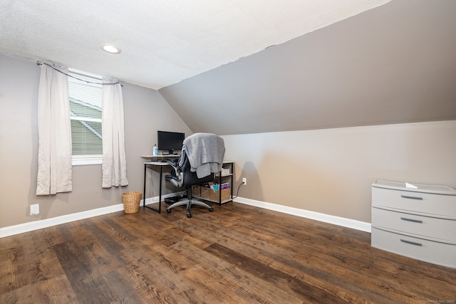 office space with vaulted ceiling, dark hardwood / wood-style floors, and a textured ceiling