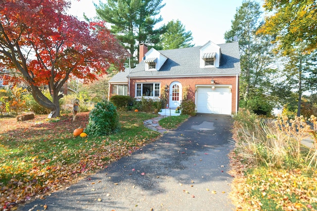 cape cod-style house featuring a garage