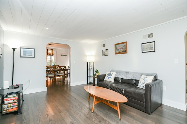 living room with dark hardwood / wood-style floors and ornamental molding