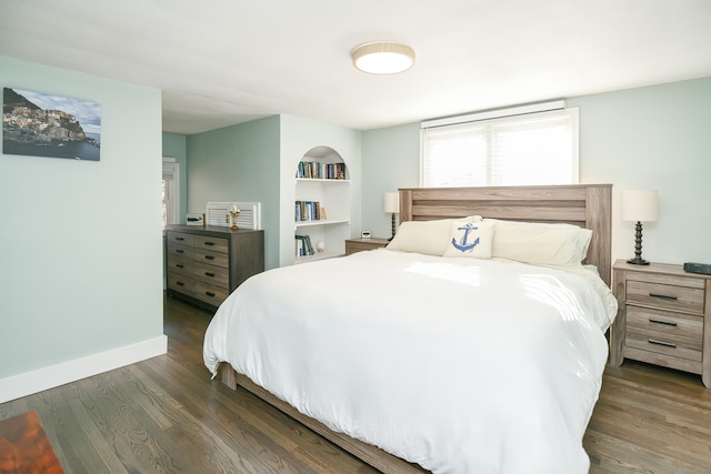 bedroom with dark hardwood / wood-style flooring