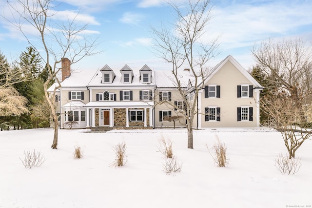 view of snow covered rear of property