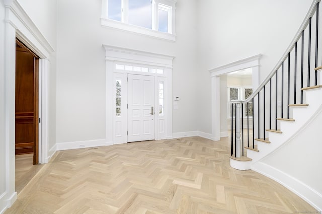 40 Hoyclo Rd, Stamford, CT 06903 - entrance foyer featuring stairway, a towering ceiling, and baseboards
