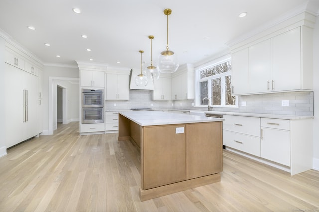 40 Hoyclo Rd, Stamford, CT 06903 - kitchen with decorative backsplash, double oven, stovetop, light wood finished floors, and light countertops