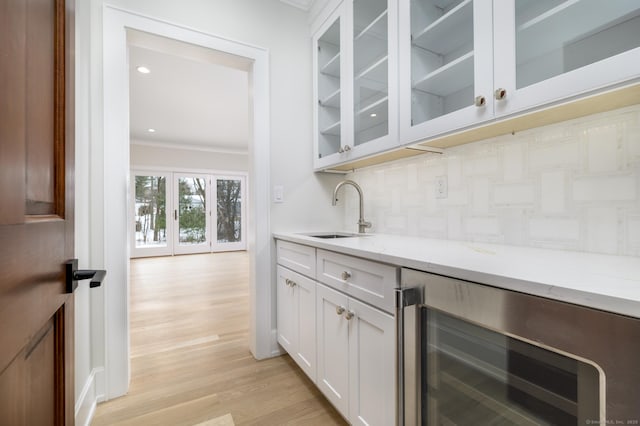 40 Hoyclo Rd, Stamford, CT 06903 - bar with a sink, decorative backsplash, light wood-style floors, ornamental molding, and wine cooler