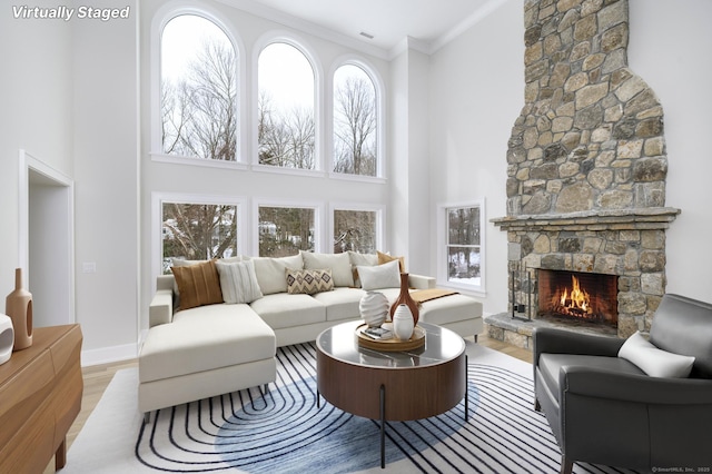 40 Hoyclo Rd, Stamford, CT 06903 - living area with a stone fireplace, a high ceiling, ornamental molding, and wood finished floors
