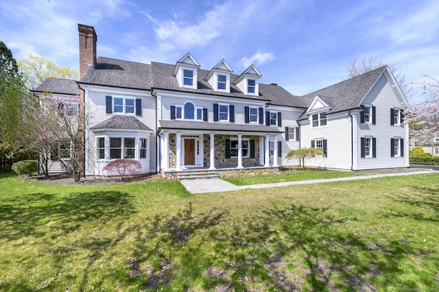 40 Hoyclo Rd, Stamford, CT 06903 - view of front of property featuring roof with shingles, a porch, a front yard, and a chimney