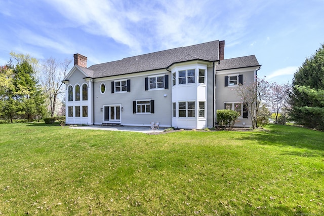 40 Hoyclo Rd, Stamford, CT 06903 - back of house featuring a chimney, a patio area, a yard, and a shingled roof