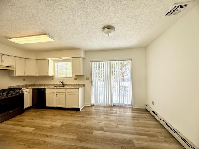 kitchen with white cabinetry, sink, a baseboard heating unit, black appliances, and light hardwood / wood-style flooring