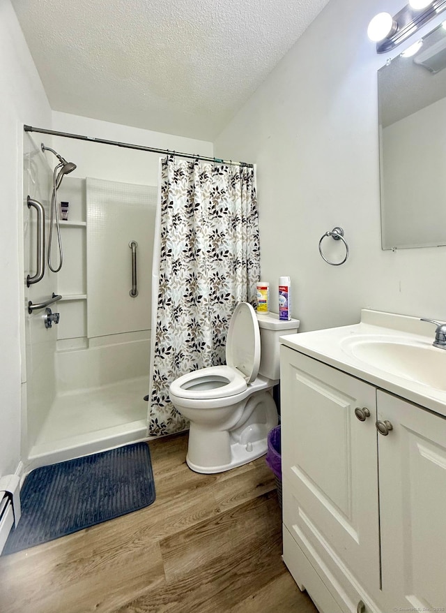 bathroom featuring hardwood / wood-style flooring, vanity, a textured ceiling, a shower with curtain, and toilet