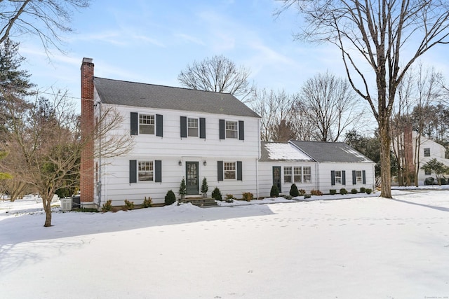 colonial house featuring central AC unit