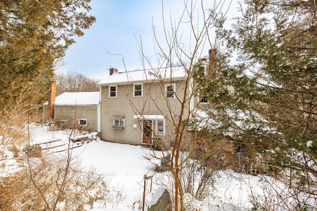 view of snow covered rear of property